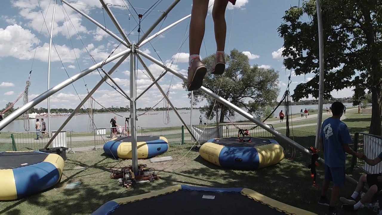 Child's legs appear above the trampoline frame.