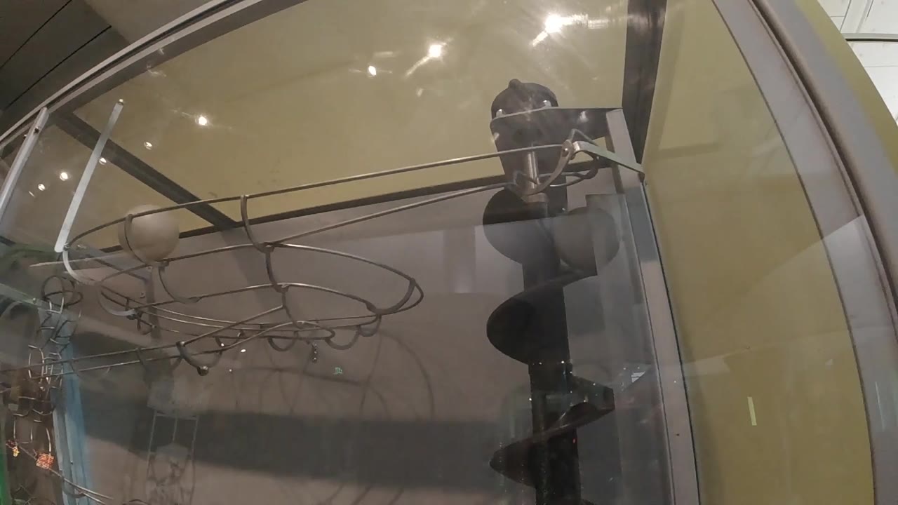Close view through glass of rods and circular wire shapes