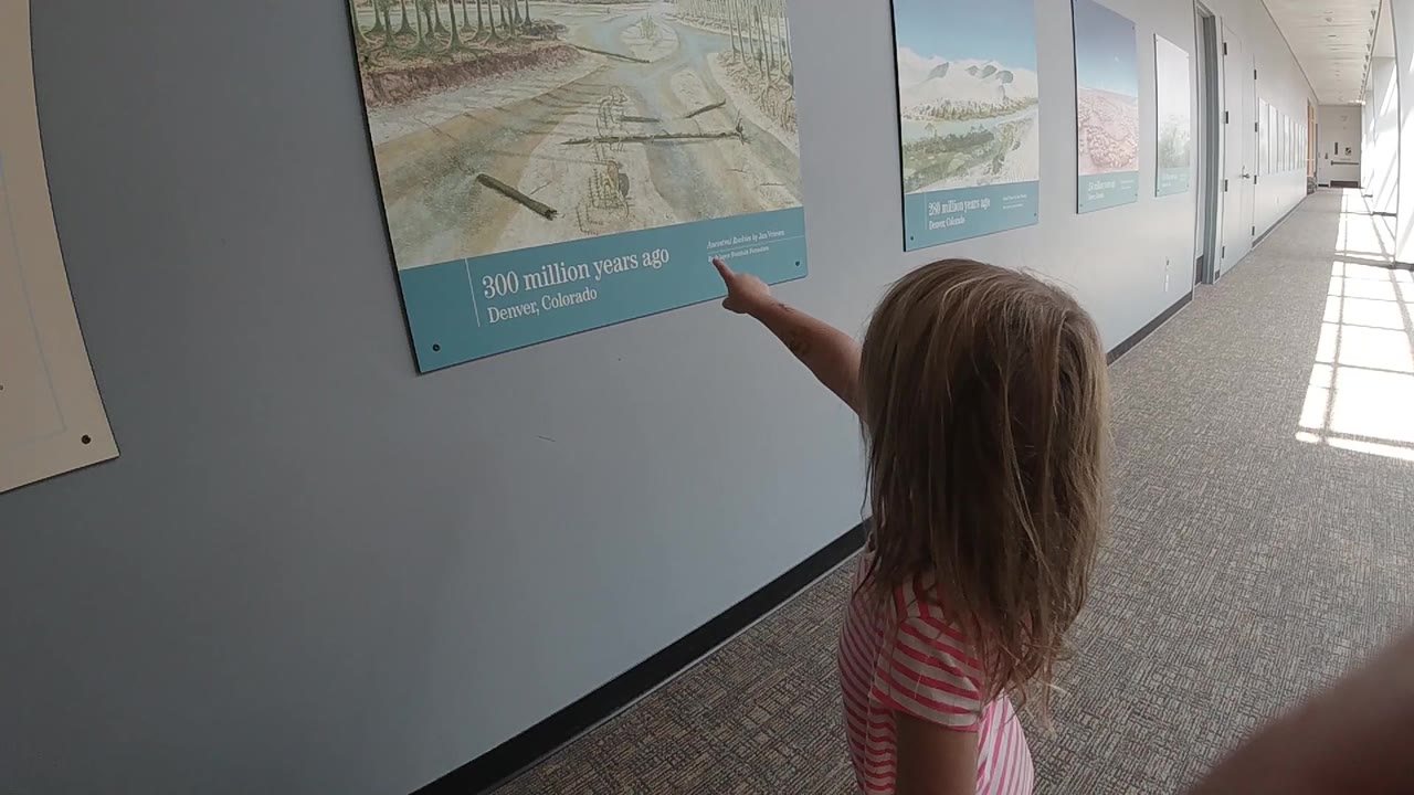 Child points at an informational display panel.