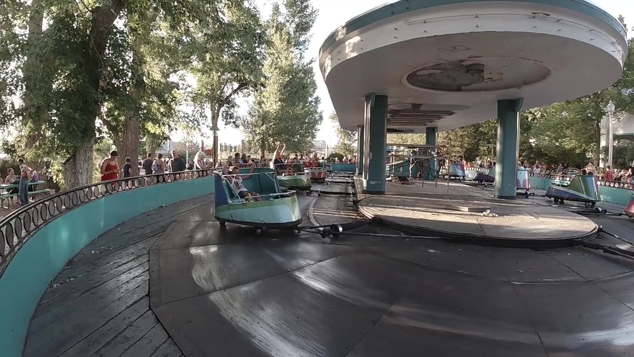 Ride car enters closer foreground on circular track