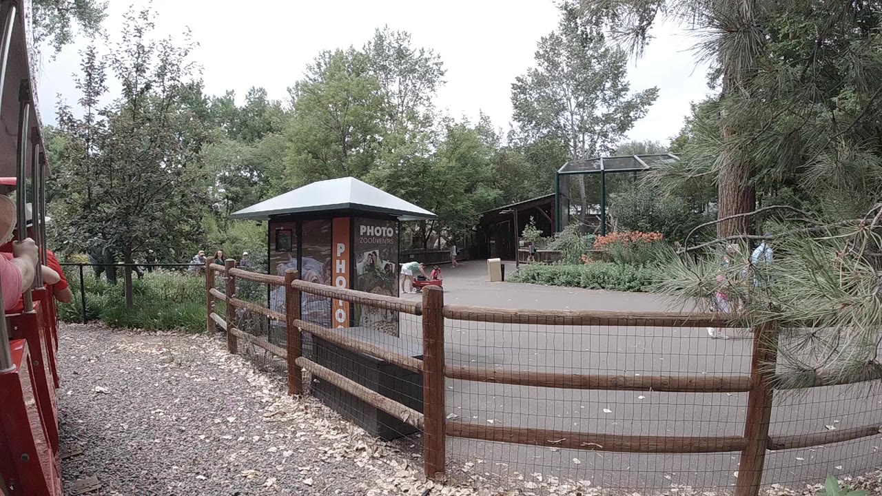Rustic fence beside a park photo booth and trees