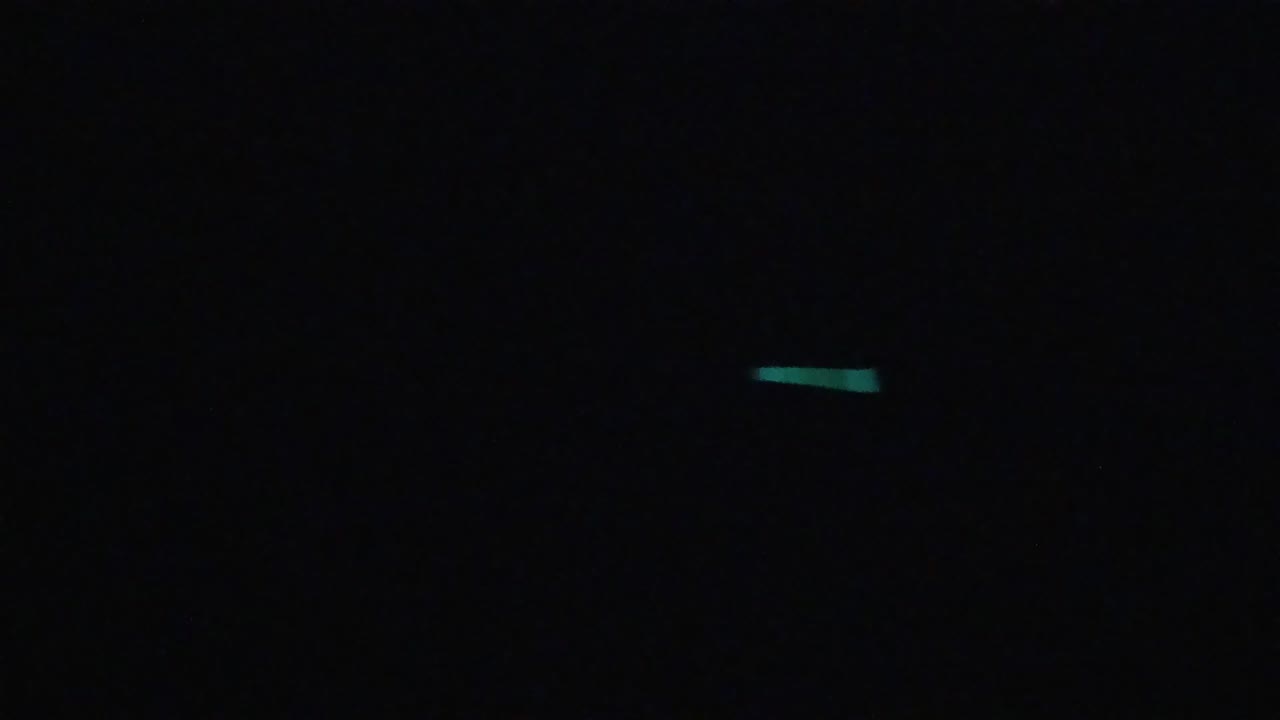 Small teal streaks in a black frame