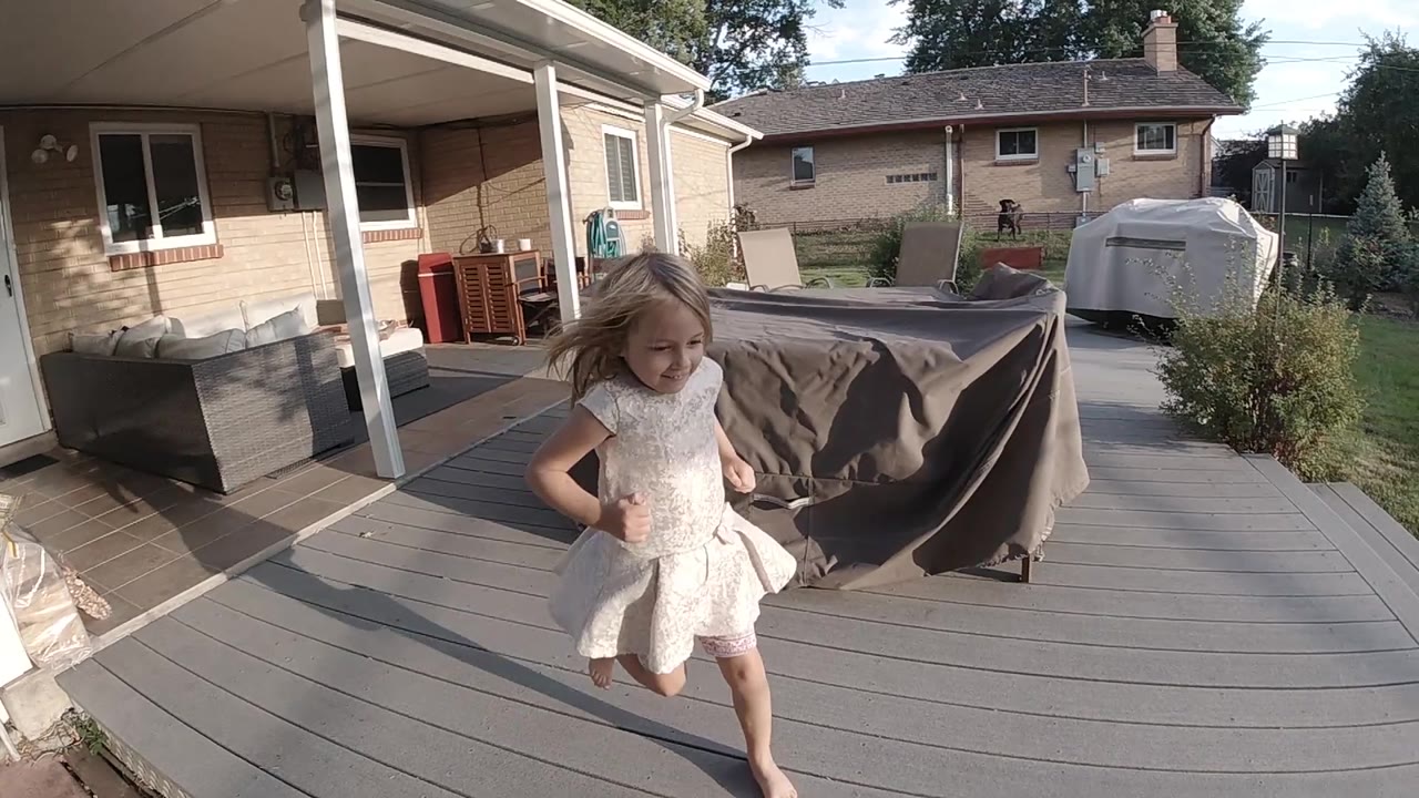Girl running past the camera on the deck.