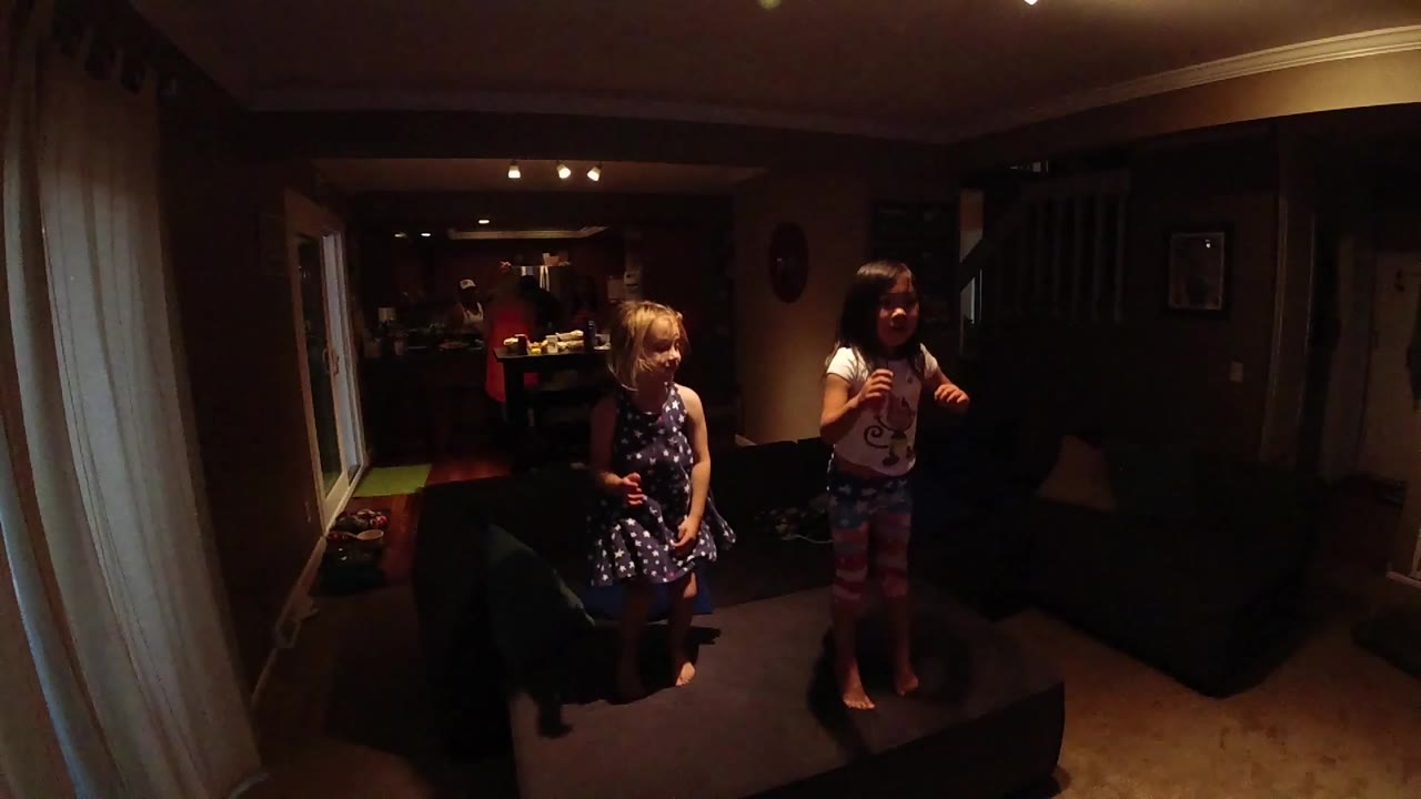 Children moving near the sofa.