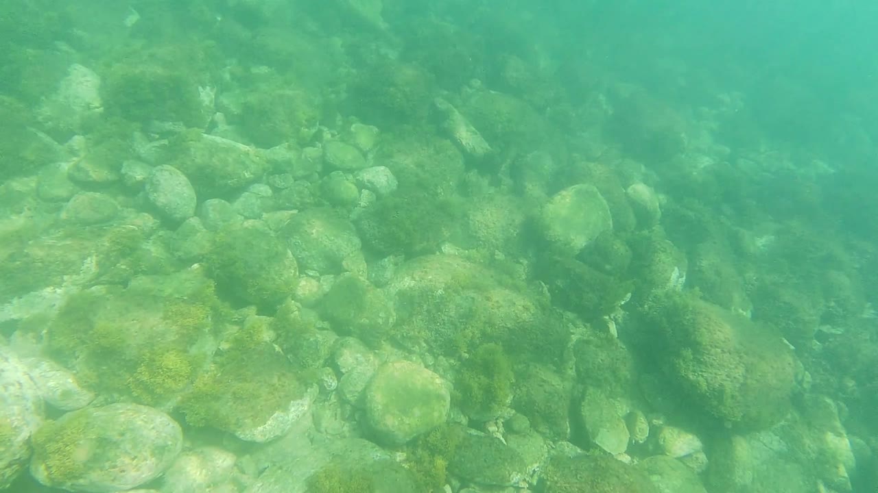 Underwater rocks with hazy turquoise water