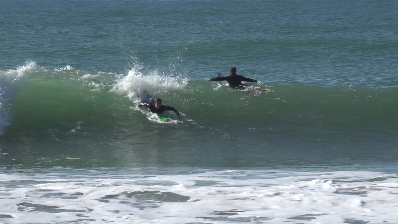 Surfer riding along the face of a breaking wave