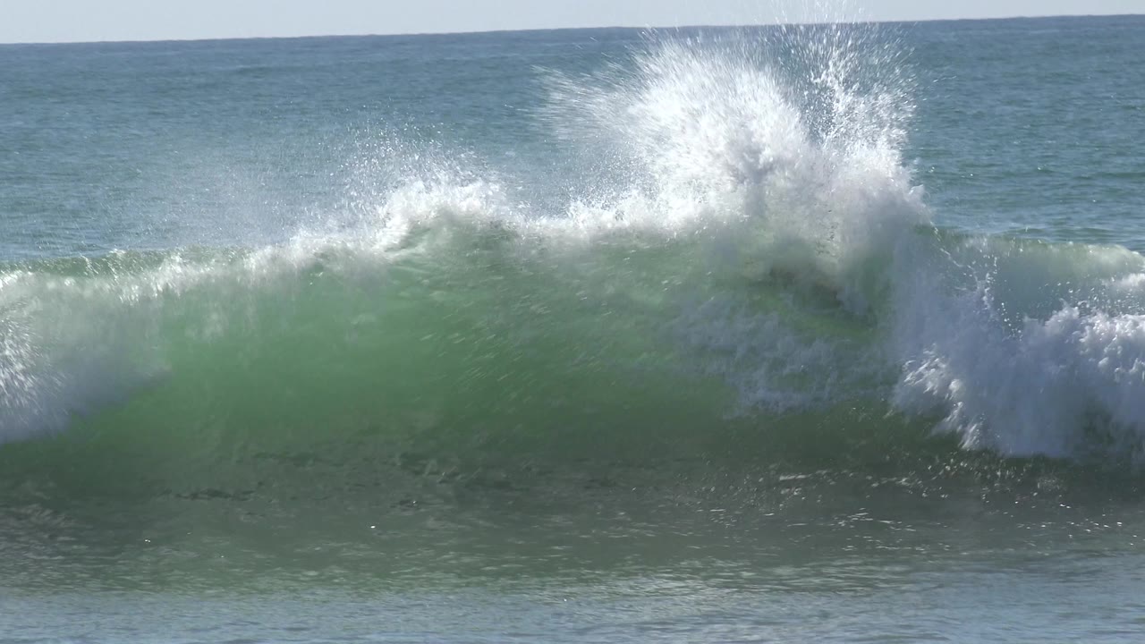 Breaking ocean wave with no visible people.