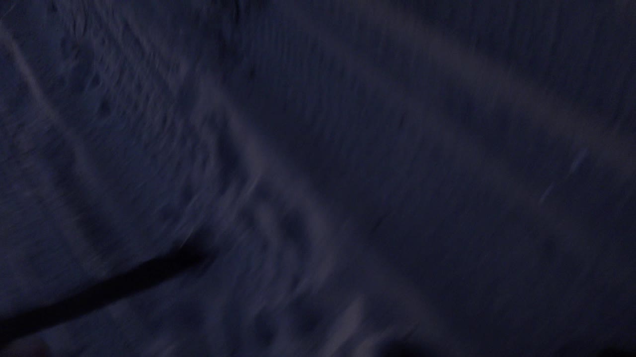 At 0:01, the Huntington Beach clip remains tightly cropped, with textured blue-gray material above a heavy black band and no readable person or face.