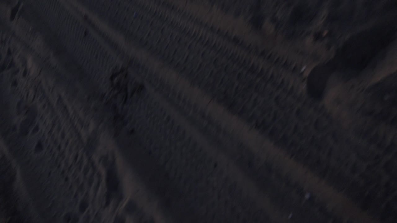 Close view of beach sand and heavy shadows.