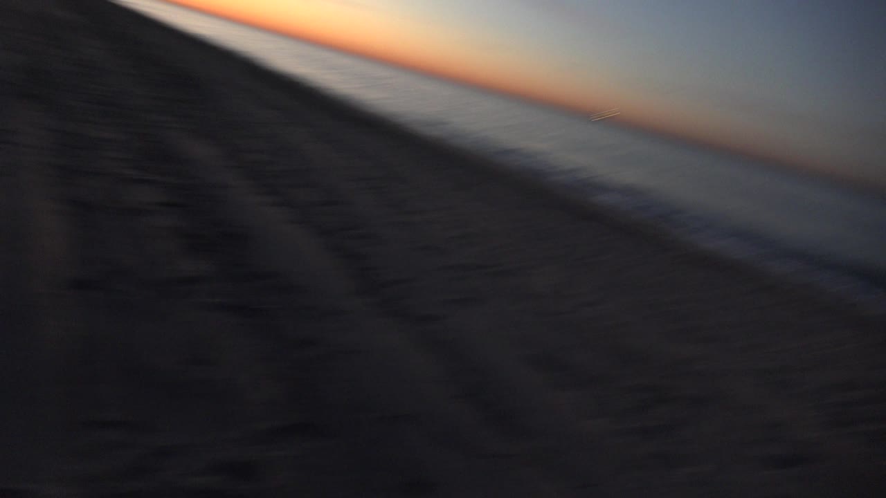 Soft blurred tilted beach and ocean at sunset.