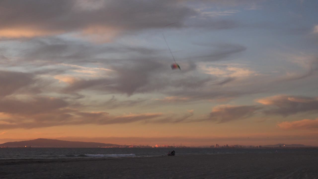 Kite lines angle down from a stunt kite near the right sky.