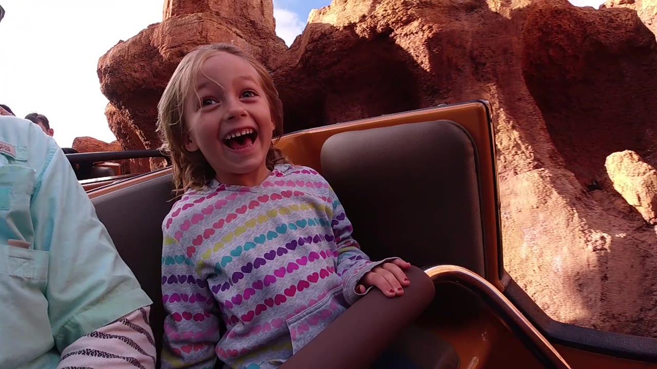 Girl laughing as the ride passes red rock scenery.