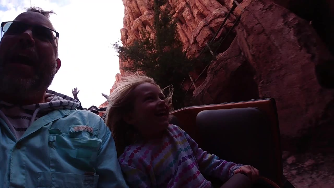 Girl looking up while the ride approaches shadow.