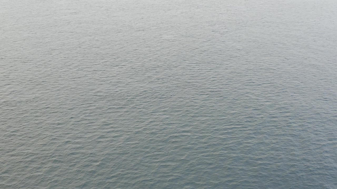 Blue-gray ocean surface in Baja California Sur fills the opening frame, with small ripples and no visible people.