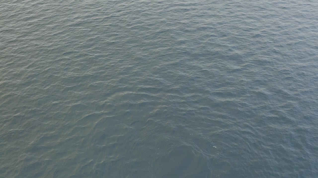 Textured ocean surface in Baja California Sur, Mexico, with soft daylight on uneven blue-green ripples and no visible people.