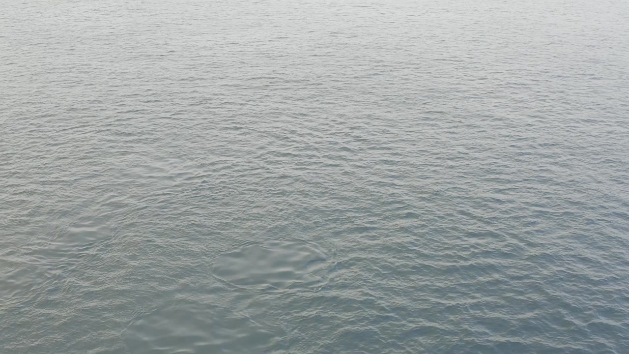 The second frame shows the Baja California Sur ocean surface with darker blue patches in the ripple pattern and no visible people.