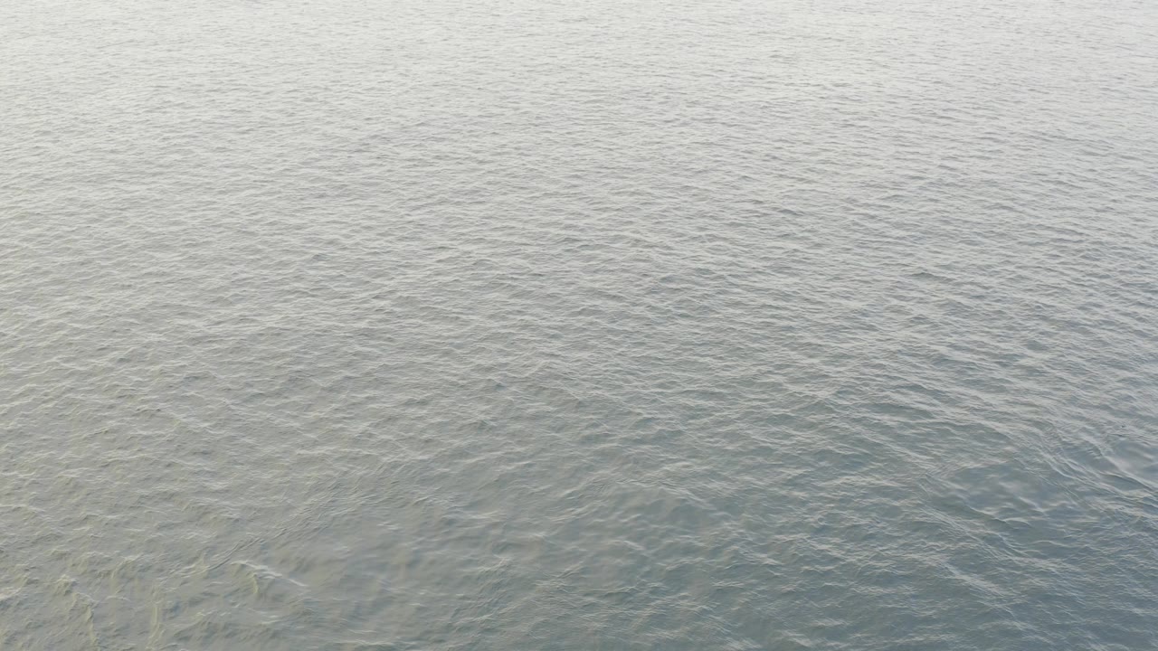 Pale blue gray ocean surface in Baja California Sur, Mexico, with fine ripples across the water and no visible people.