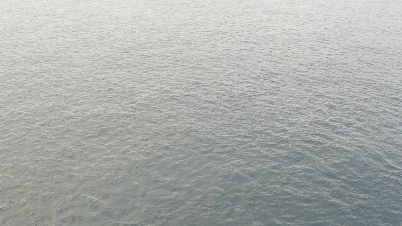 Calm Baja California Sur ocean water with darker blue gray ripple bands moving across the middle of the frame and no visible people.