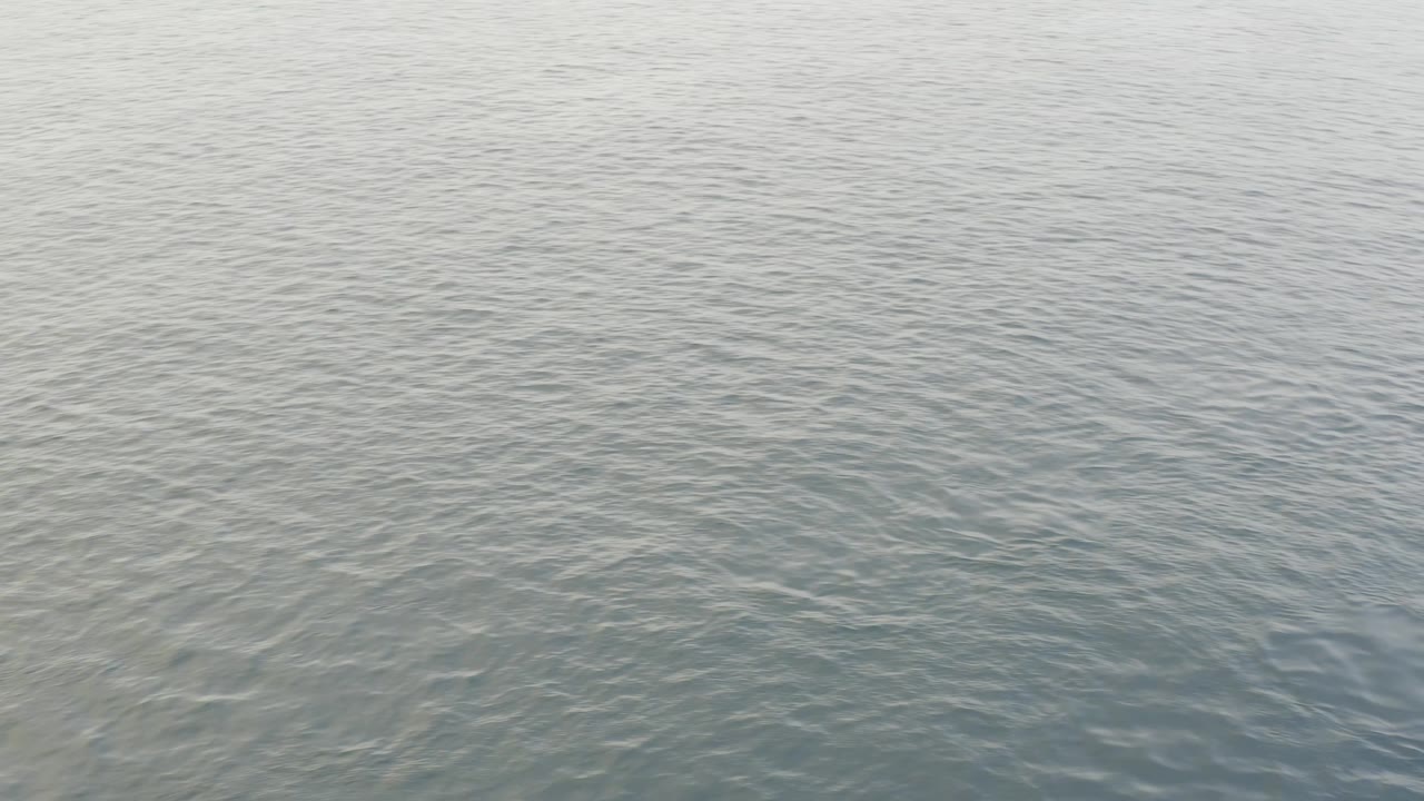 Open ocean water in Baja California Sur, Mexico, with low wave texture, faint highlights, and no visible people or vessels.