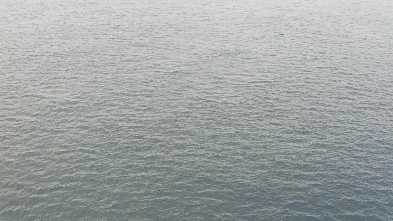 Calm blue-gray ocean water with fine ripples