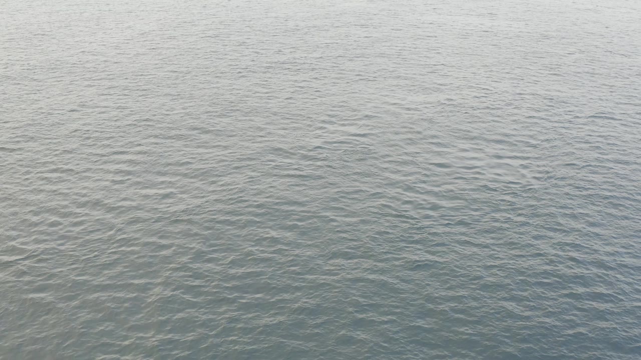 A pale patch of reflected light spreads across the rippled ocean surface in Baja California Sur, with no land, boats, or visible people.
