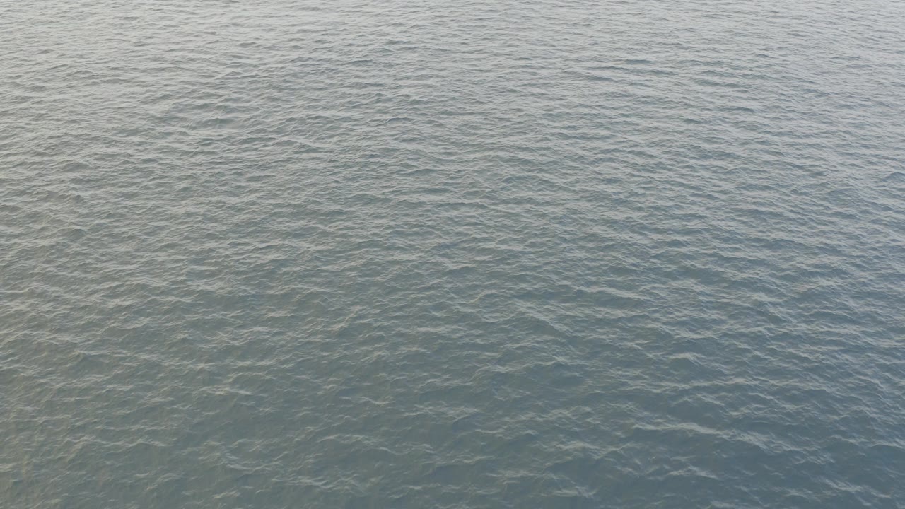 Opening frame of pale blue green water in Baja California Sur, Mexico, with small surface ripples and no visible people.