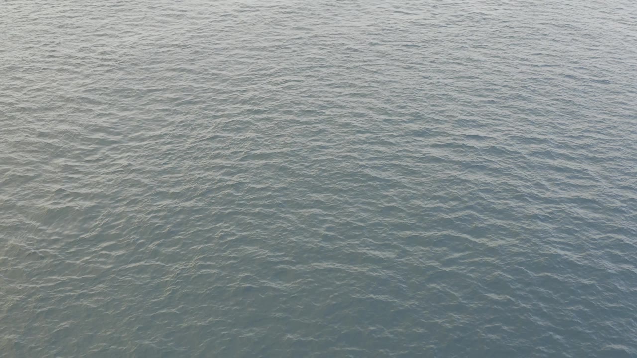 Fourth frame shows an even field of small ocean ripples in Baja California Sur, Mexico, with muted blue green color and no visible people.