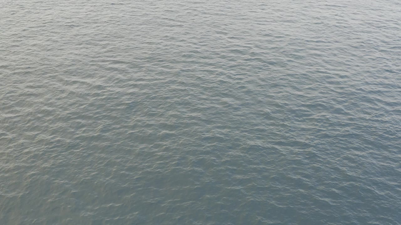 Blue-green ocean surface in Baja California Sur fills the frame at the start of the clip, with fine ripples and no visible people.