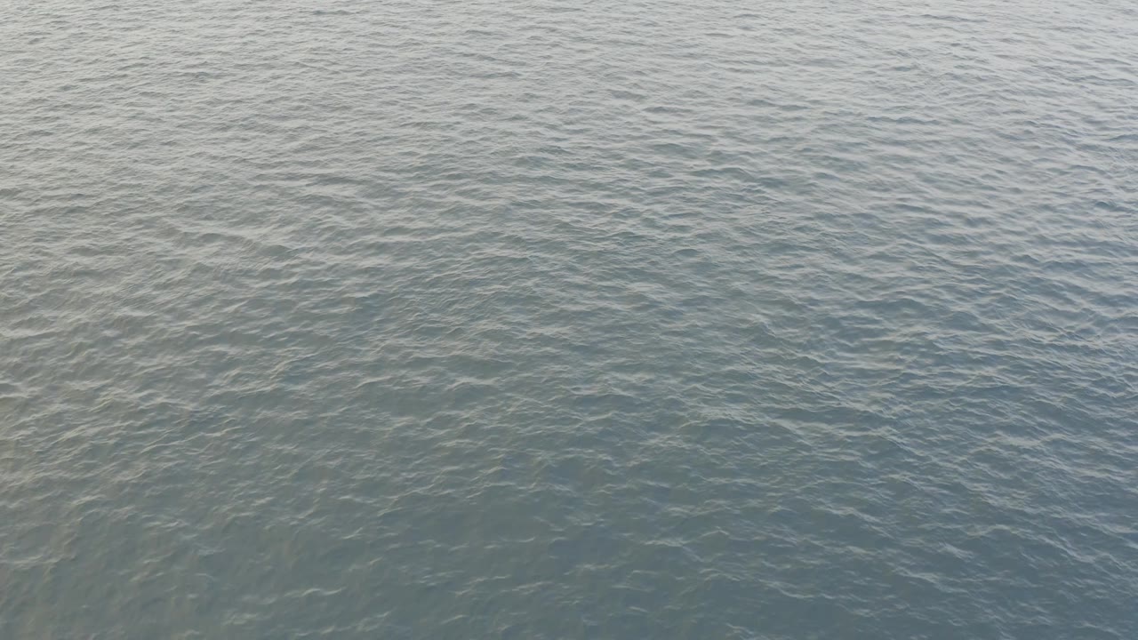Open ocean water with overlapping ripples.