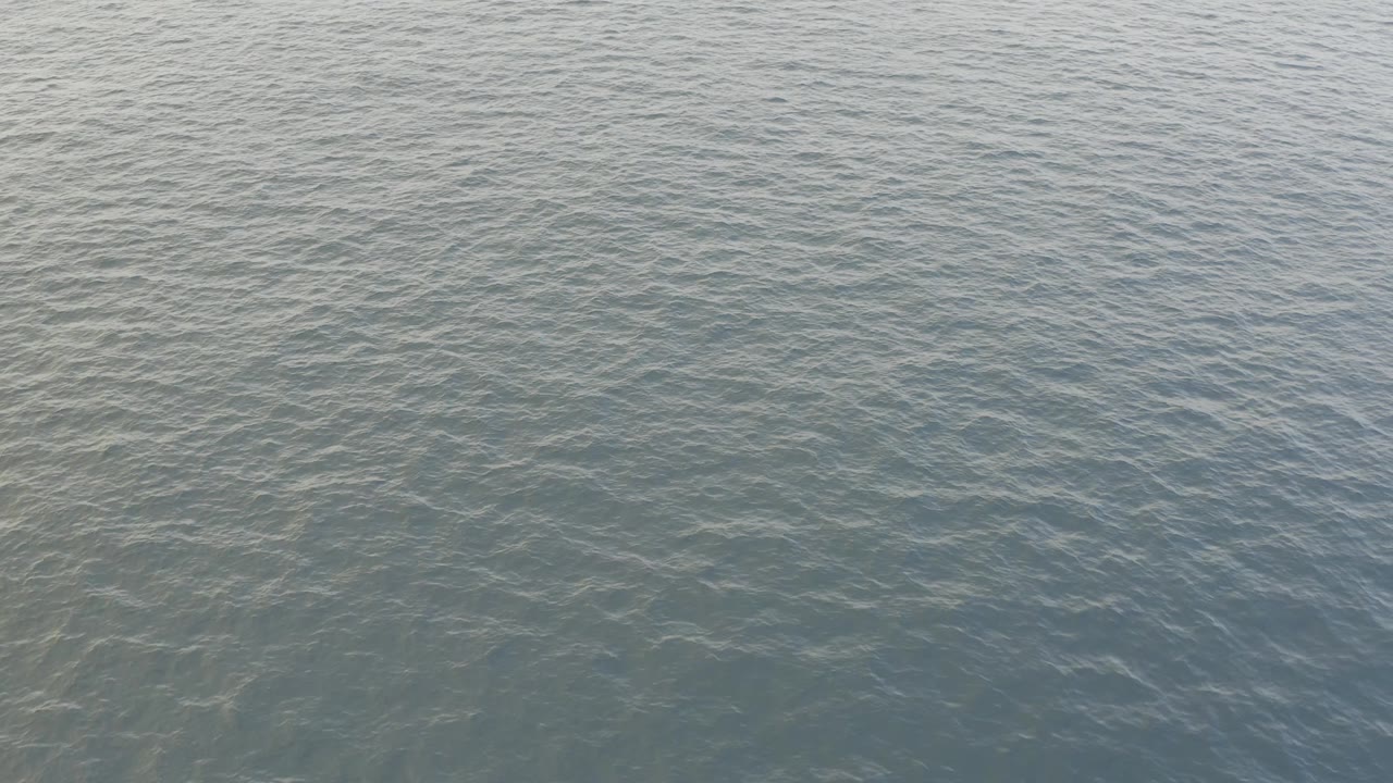 Open water with pale ripples and muted blue gray color.