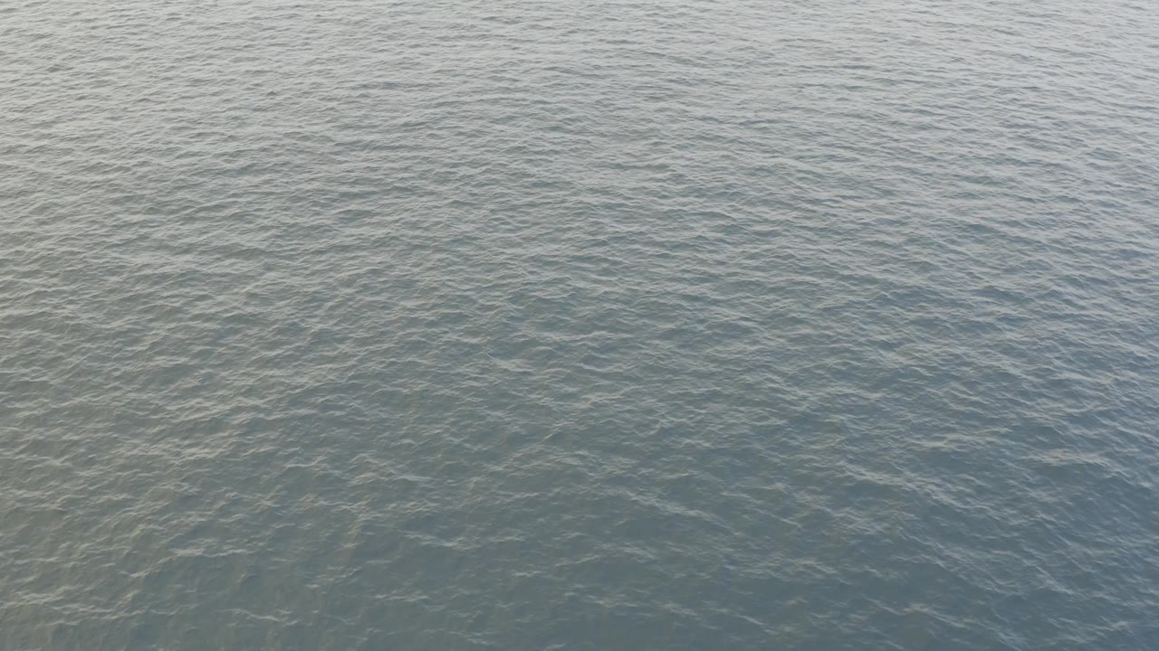 Overhead view of muted blue ocean in Baja California Sur, Mexico, with subtle wind-wave patterning and no visible people, boats, or land.