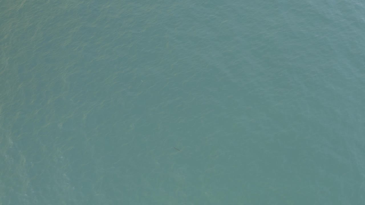 High-angle view of turquoise-blue water in Baja California Sur, Mexico, with light ripple patterns and no visible people.