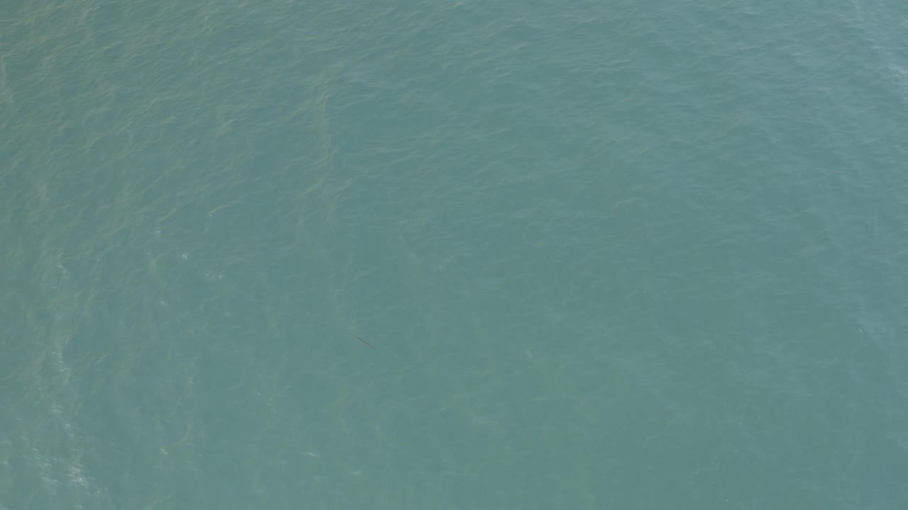 Blue-green ocean surface in Baja California Sur, Mexico, with slightly darker ripple bands across the water and no visible people.