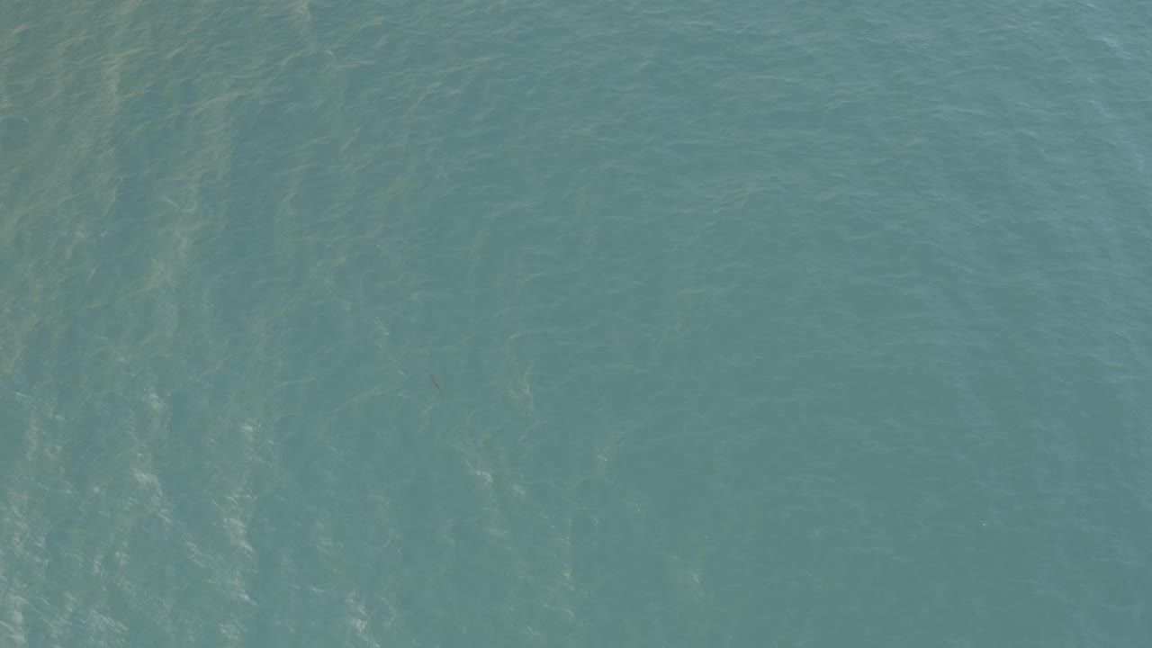 Calm Baja California Sur ocean water shows pale ripples and soft reflected light across a full-frame sea surface with no visible people.
