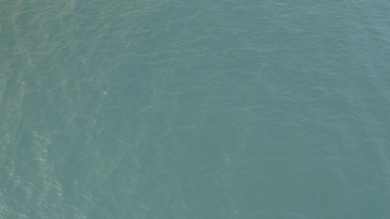Clear blue-green water surface in Baja California Sur, Mexico, with faint ripple lines and no visible people.