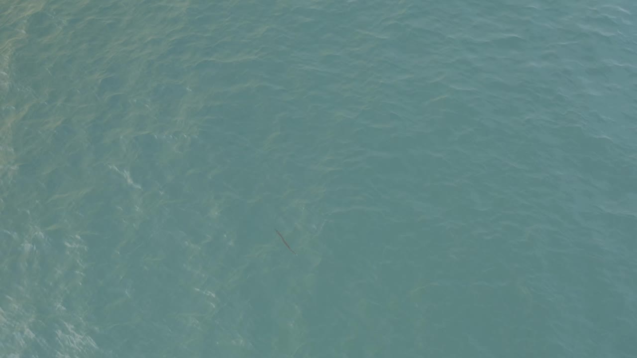 Aerial-style view over turquoise water in Baja California Sur, Mexico, showing fine wave lines across the frame and no visible people.