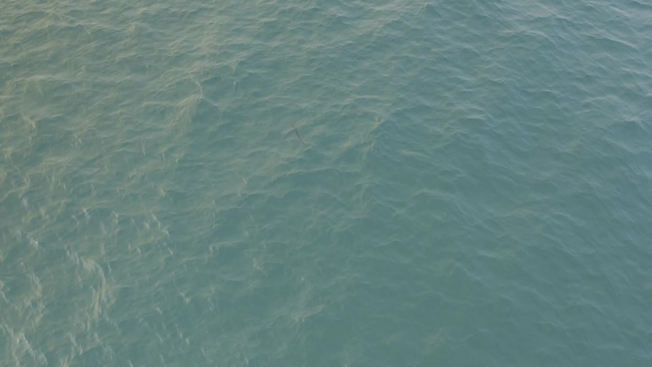Muted turquoise water in Baja California Sur fills the frame with diagonal surface ripples and no visible people or objects.