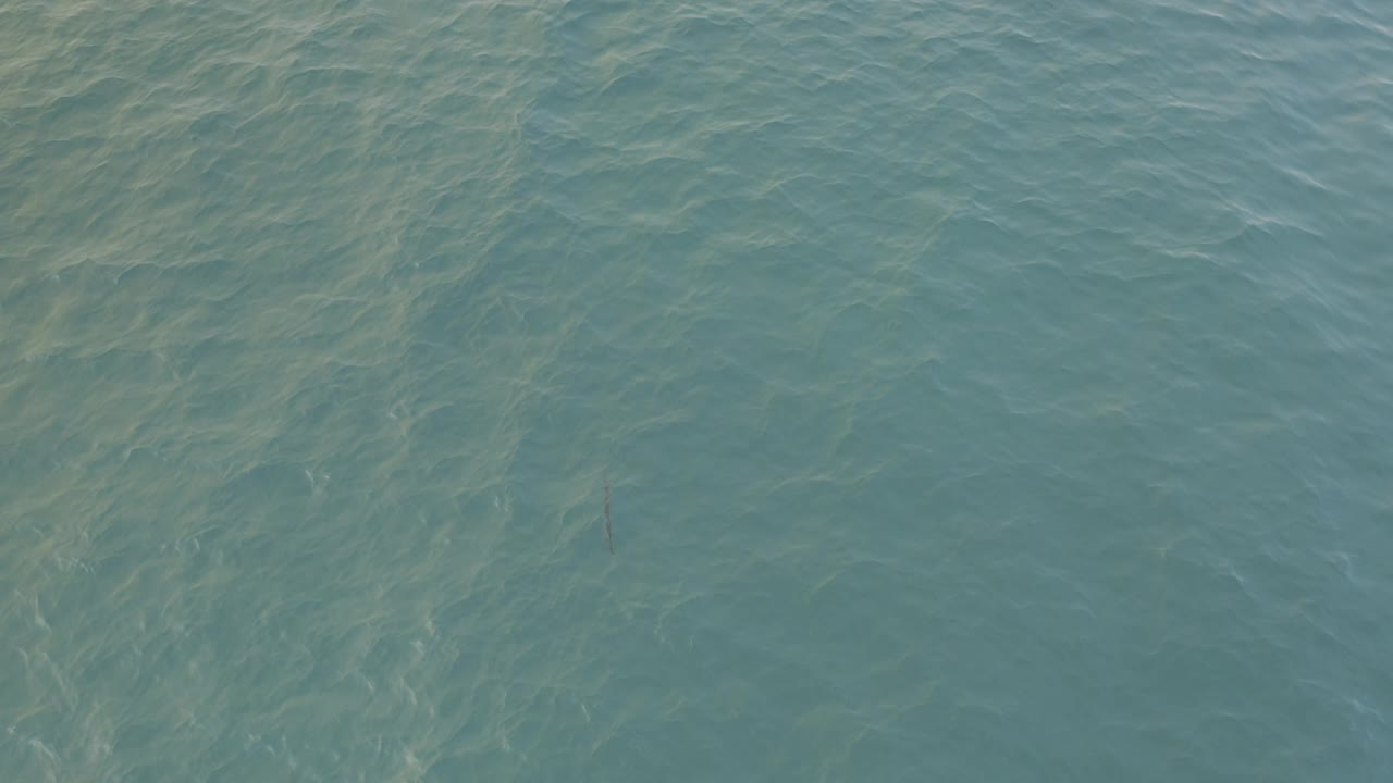 Blue-green seawater seen from above with pale ripples.
