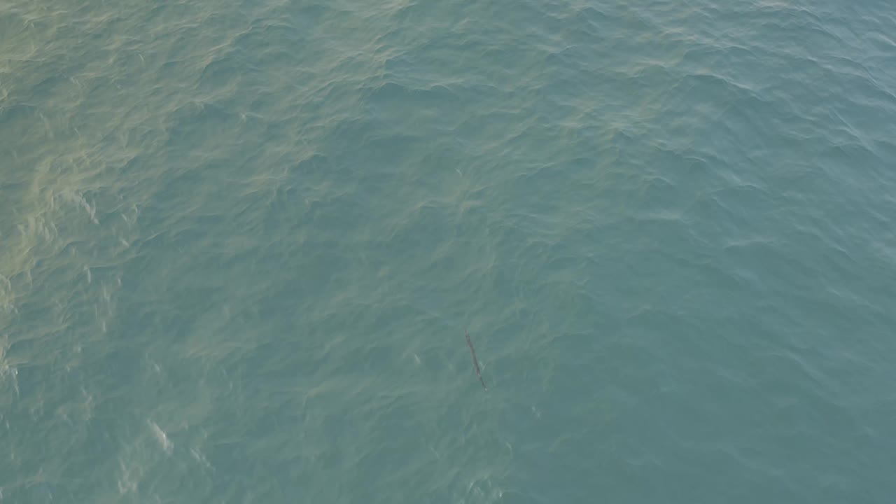 High-angle Baja California Sur water view with brighter ripples across the upper area, softer blue-green tones below, and no visible people.