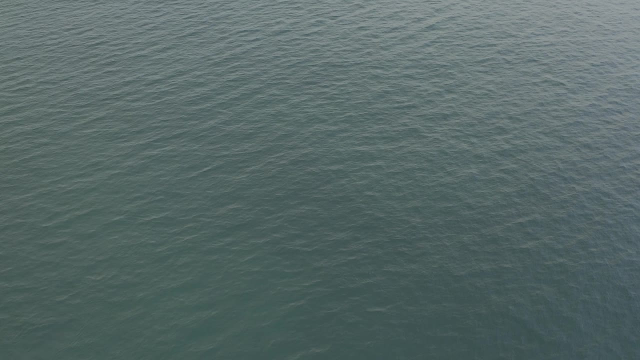 Downward-looking ocean surface in Baja California Sur, Mexico, showing denser ripple texture near the center and no visible people.