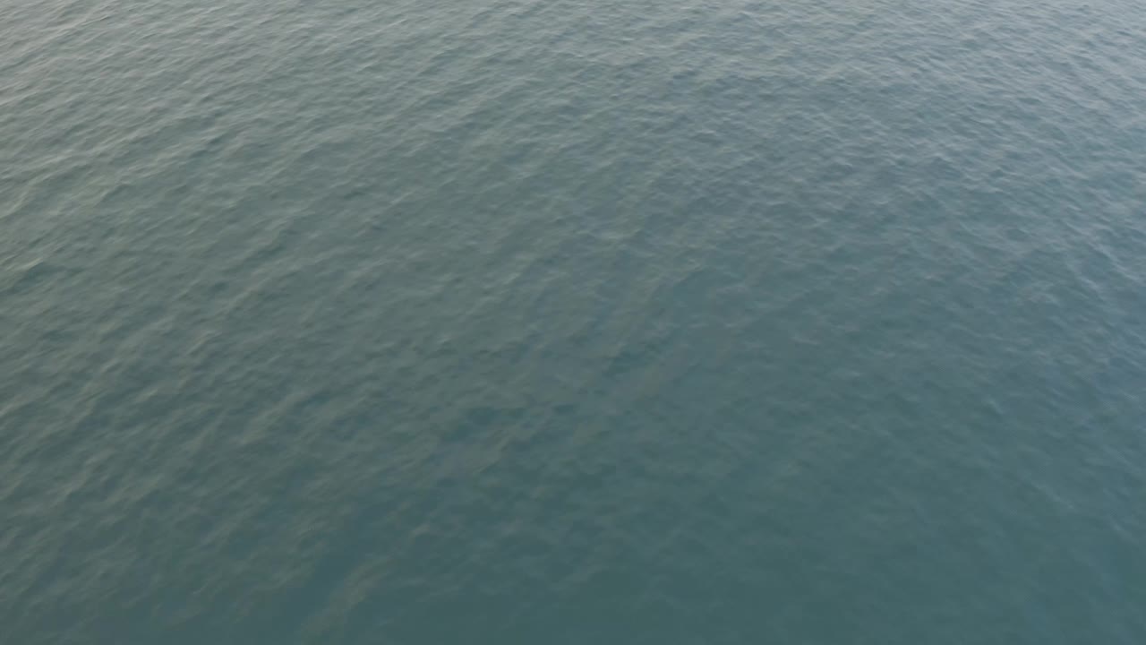 Textured ocean surface with diagonal ripples.