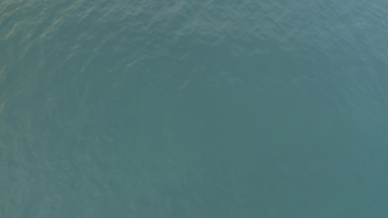 Overhead view of teal ocean water in Baja California Sur, Mexico, with faint ripples crossing the surface and no visible people.