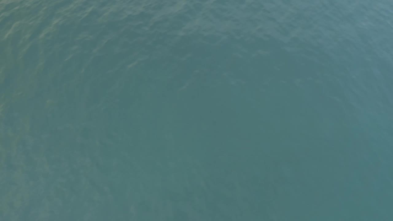 Blue-green ocean surface in Baja California Sur, Mexico, with pale wave streaks near the upper edge and no visible people.