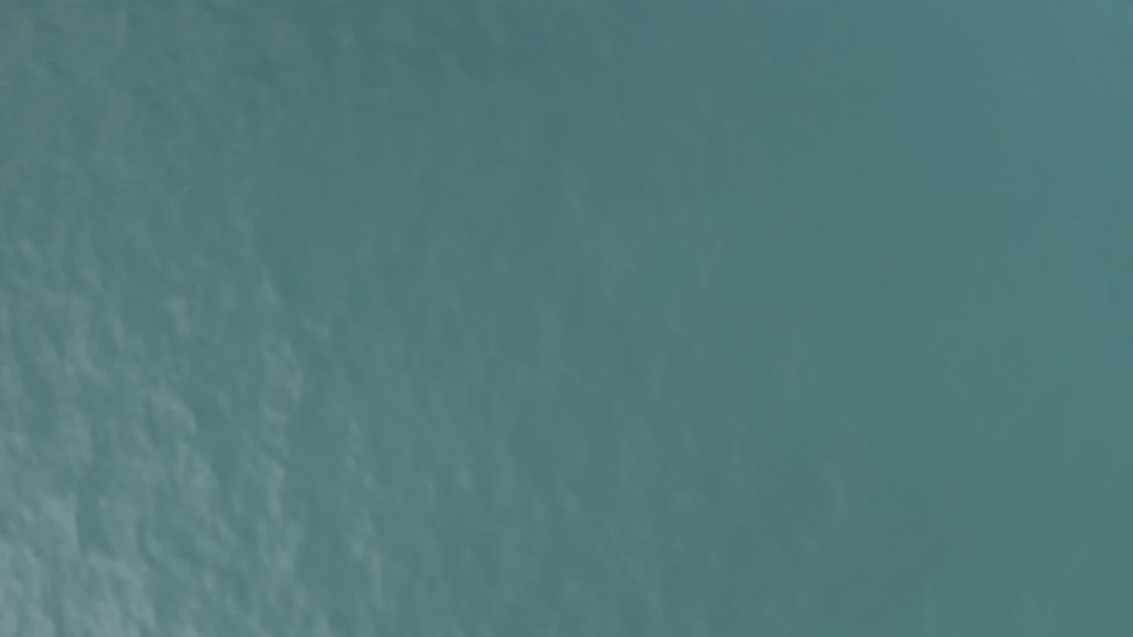 Muted teal ocean water in Baja California Sur, Mexico, with faint diagonal ripple texture and no boats, shoreline, or visible people.