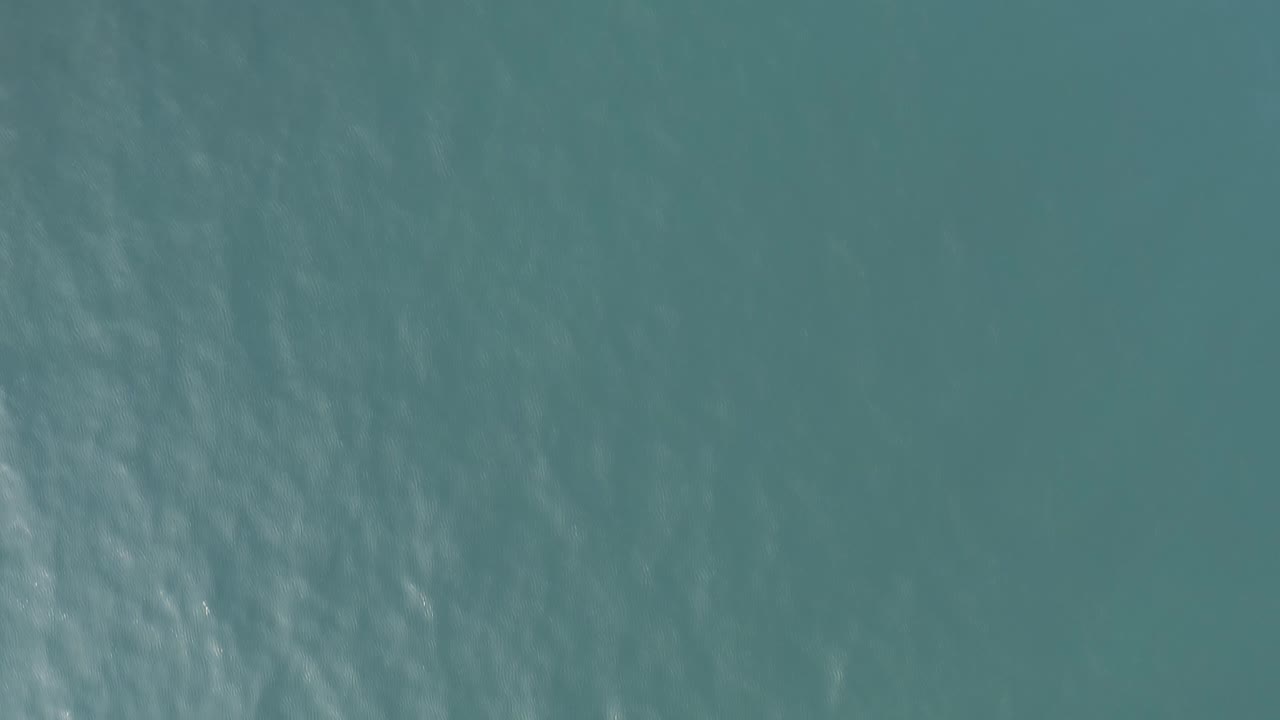 Open blue-green sea surface in Baja California Sur, Mexico, with soft wind texture across the water and no visible people.