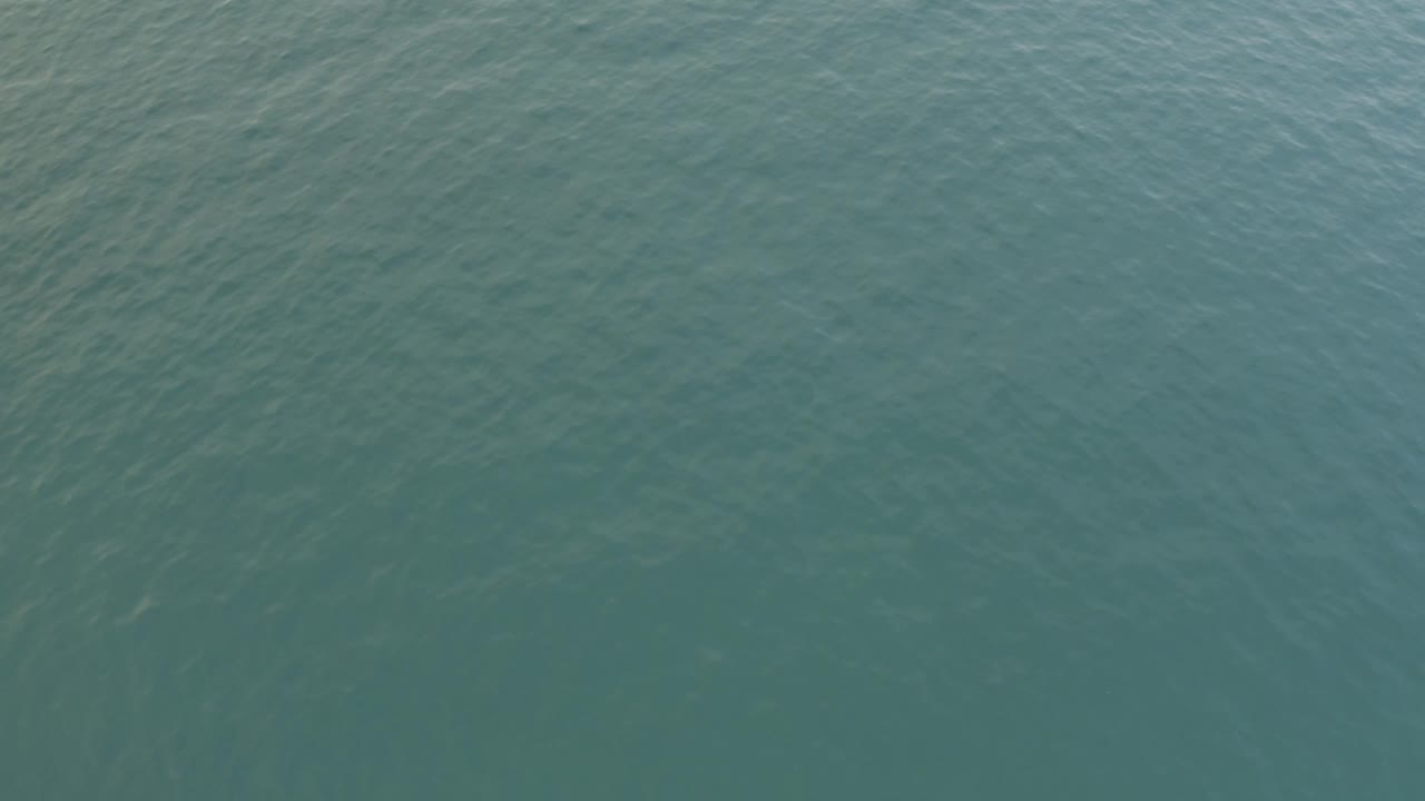 Blue green ocean surface with faint ripples