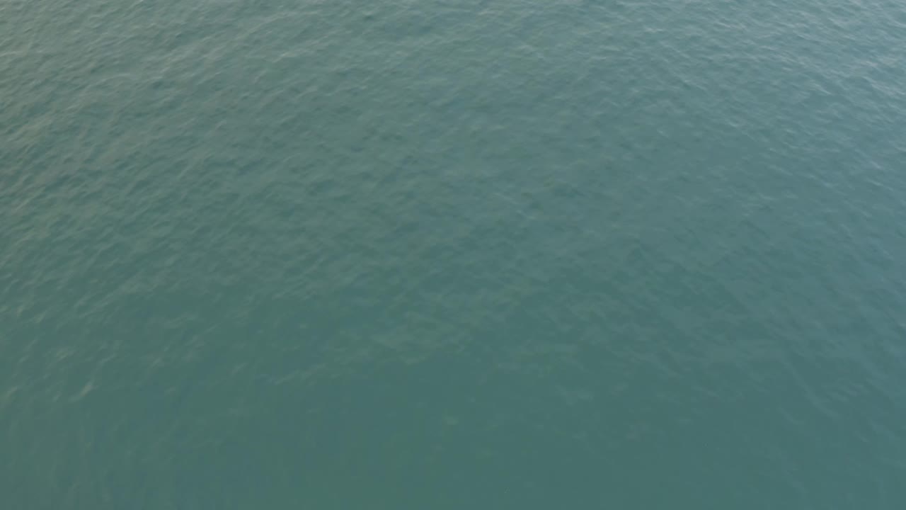Blue green ocean fills the frame in Baja California Sur, Mexico, with slightly smoother water texture near the center and no visible people.