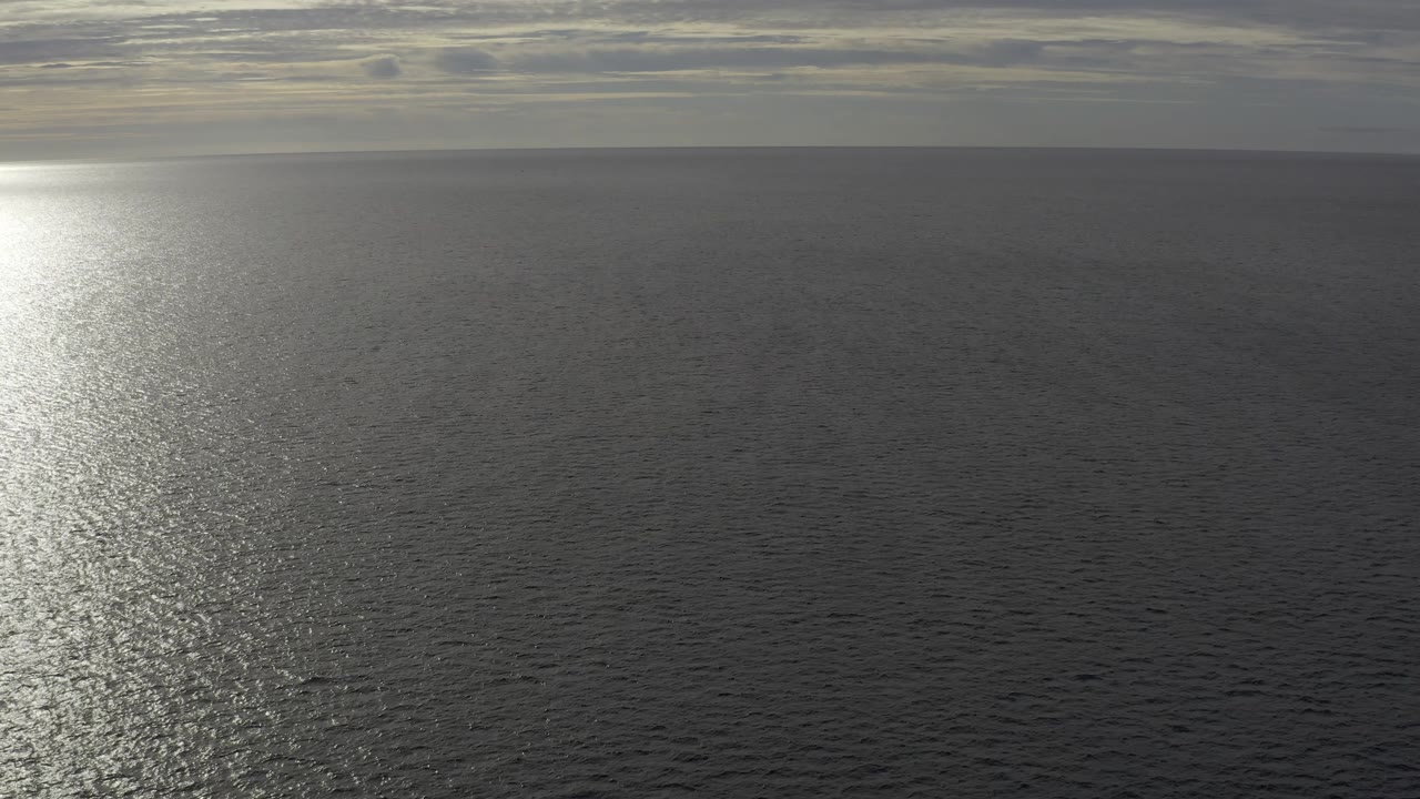 A closer-feeling portion of Baja California Sur Mexico ocean shows the reflection moving toward the left edge, with textured ripples and no visible people.