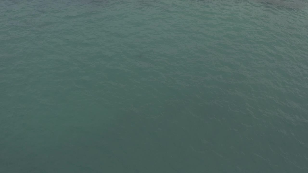 Overhead view of green-blue ocean water in Baja California Sur, Mexico, with subtle ripple texture and no visible people.