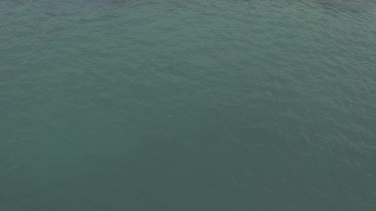 Aerial frame of rippling green ocean in Baja California Sur, Mexico, with slightly darker water tone across the surface and no visible people.